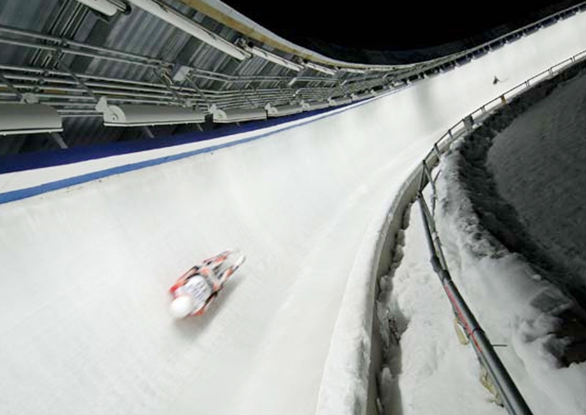 Luge athlete racing on an ice track